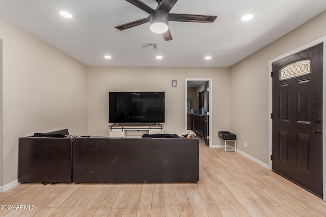 living room with ceiling fan and light hardwood / wood-style flooring