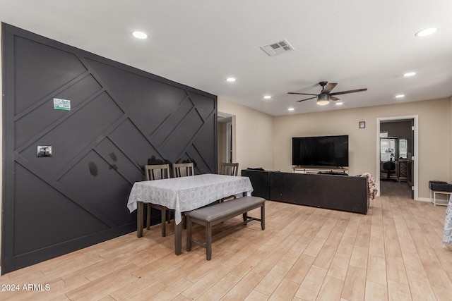 dining area with light wood-type flooring and ceiling fan