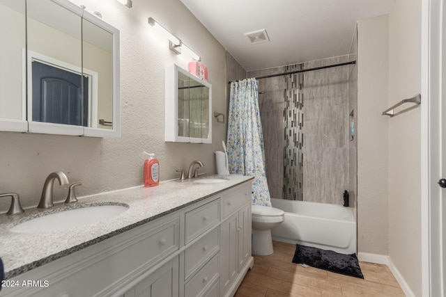 full bathroom featuring hardwood / wood-style floors, vanity, shower / bath combo, and toilet