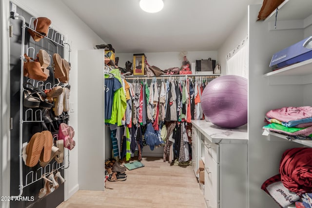 walk in closet with light wood-type flooring