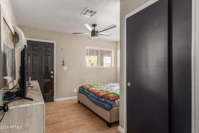 bedroom with light hardwood / wood-style floors and ceiling fan