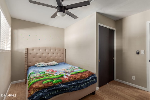 bedroom with hardwood / wood-style floors and ceiling fan