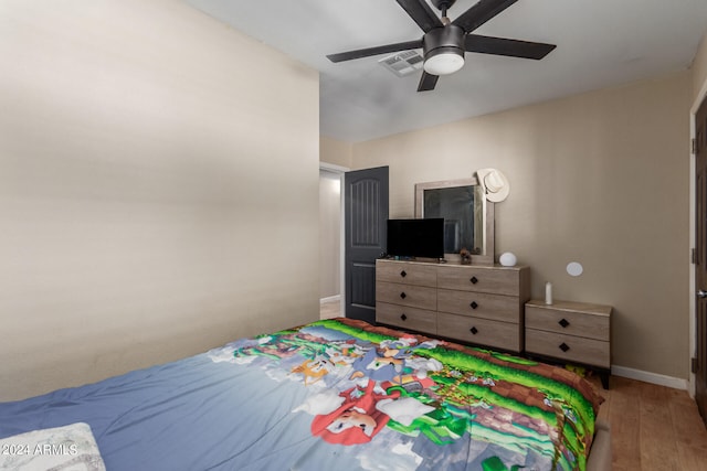 bedroom with hardwood / wood-style flooring and ceiling fan