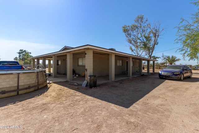 view of front of property featuring a carport