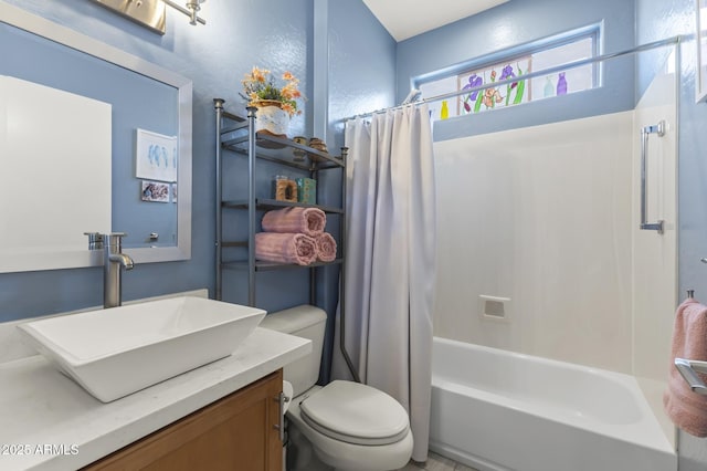 full bathroom featuring vanity, toilet, and shower / tub combo