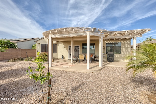 rear view of property with a pergola and a patio area