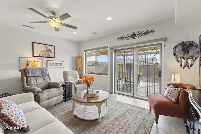 living room featuring tile patterned flooring and ceiling fan