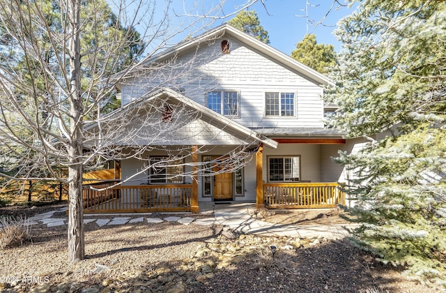 rear view of property with a porch