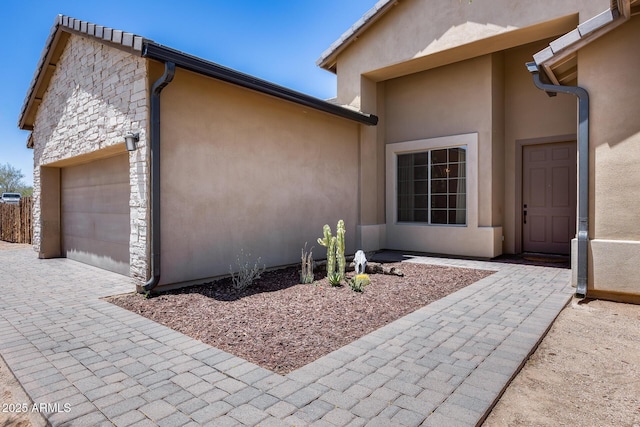 30511 N 162nd Way, Scottsdale, AZ 85262 - view of home's exterior featuring an attached garage, stucco siding, stone siding, and driveway