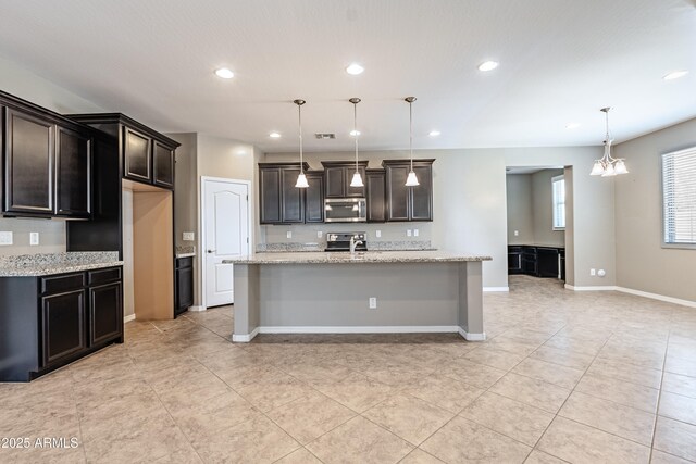 4277 N 180th Ln, Goodyear, AZ 85395 - kitchen with stainless steel appliances, recessed lighting, light tile patterned floors, pendant lighting, and light stone counters