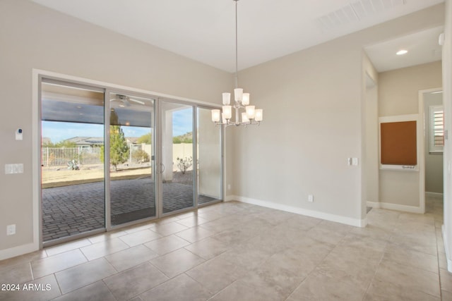 spare room featuring light tile patterned flooring and ceiling fan with notable chandelier