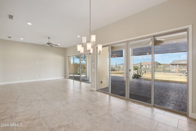 unfurnished room with ceiling fan with notable chandelier and light tile patterned floors