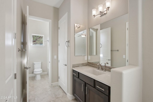 bathroom featuring ceiling fan, vanity, and toilet