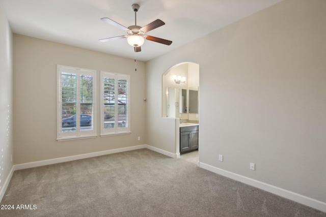 spare room with light colored carpet and ceiling fan