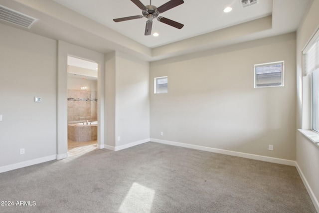 spare room featuring ceiling fan and light carpet