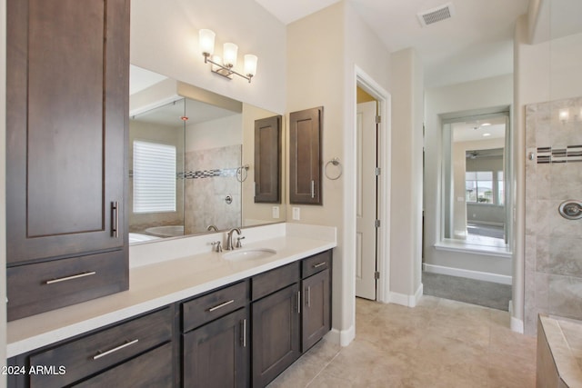 bathroom featuring tile patterned flooring, vanity, and independent shower and bath