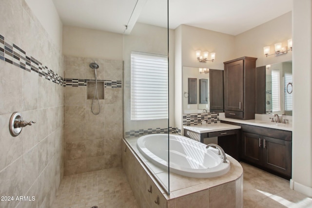 bathroom featuring tile patterned flooring, plenty of natural light, independent shower and bath, and vanity