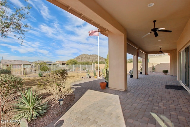 view of patio featuring a mountain view and ceiling fan