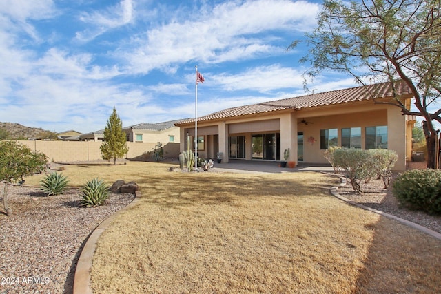 rear view of house featuring a lawn