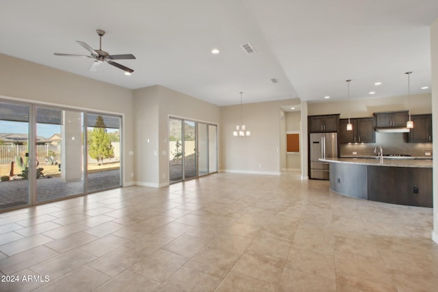 unfurnished living room featuring ceiling fan with notable chandelier and light tile patterned floors