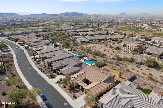 birds eye view of property with a mountain view