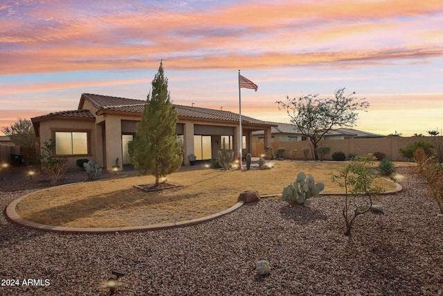 view of back house at dusk