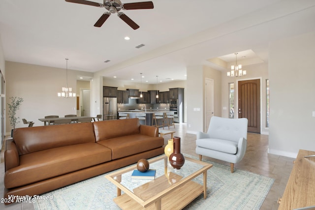 living room featuring ceiling fan with notable chandelier