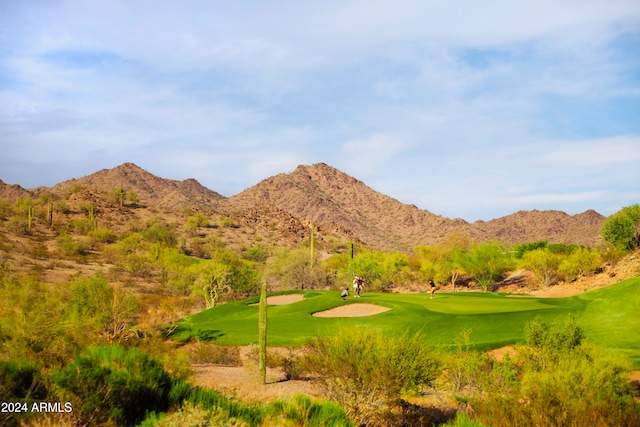 surrounding community with a mountain view and a yard