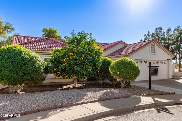 1201 E Campbell Ave, Gilbert, AZ 85234 - view of front of house featuring driveway, stucco siding, a tiled roof, and an attached garage