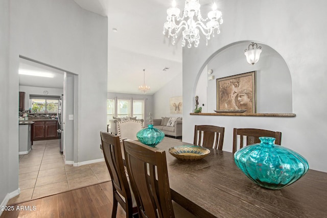 1201 E Campbell Ave, Gilbert, AZ 85234 - dining room featuring a chandelier, healthy amount of natural light, a high ceiling, and light wood-type flooring