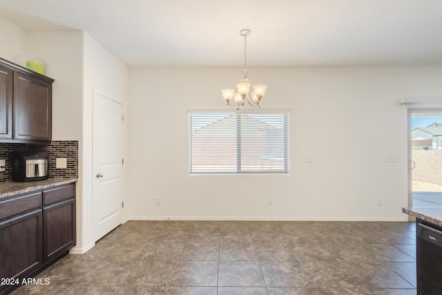 dining area with tile patterned floors and a chandelier