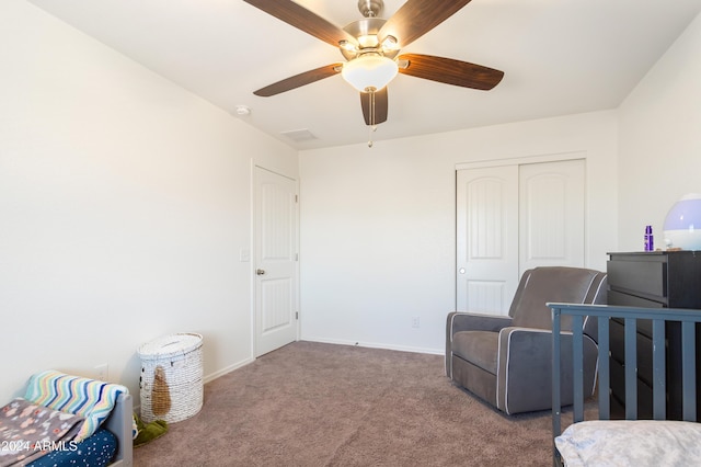 carpeted bedroom with ceiling fan and a closet