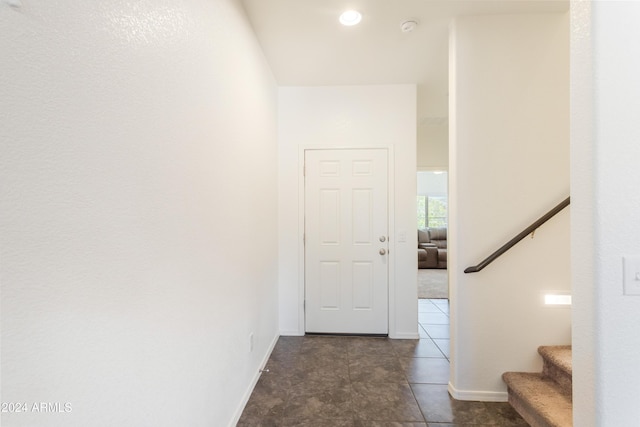 corridor featuring dark tile patterned floors