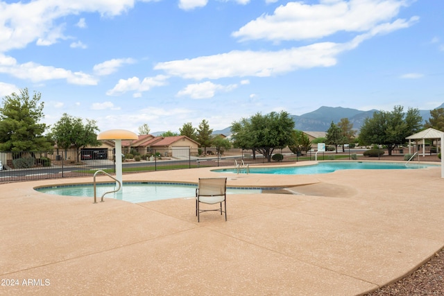 view of swimming pool featuring a mountain view