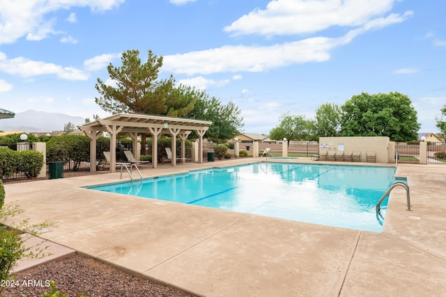 view of swimming pool featuring a mountain view and a patio