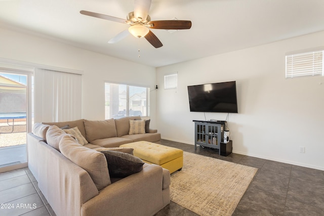 tiled living room with ceiling fan