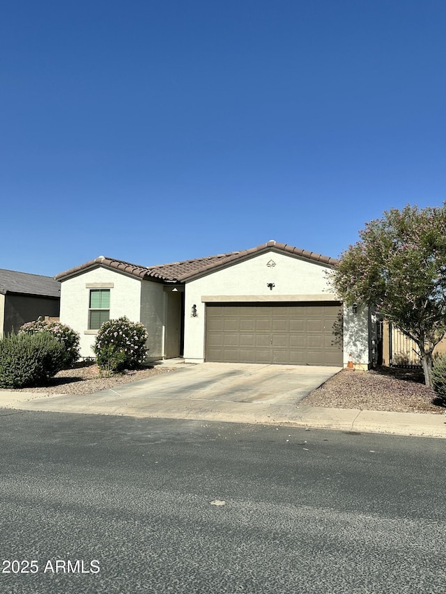 724 S 11th St, Coolidge, AZ 85128 - ranch-style house with an attached garage, concrete driveway, stucco siding, and a tile roof