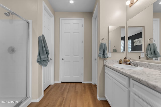 724 S 11th St, Coolidge, AZ 85128 - bathroom featuring a stall shower, vanity, and wood finished floors