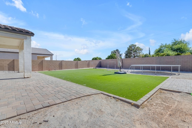 724 S 11th St, Coolidge, AZ 85128 - fenced backyard featuring a trampoline and a patio