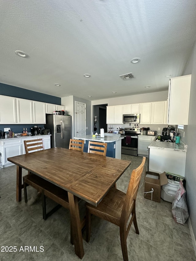 724 S 11th St, Coolidge, AZ 85128 - dining space with recessed lighting and a textured ceiling