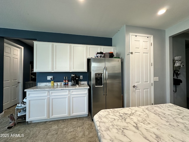 724 S 11th St, Coolidge, AZ 85128 - kitchen featuring stainless steel fridge, white cabinetry, light stone counters, and recessed lighting
