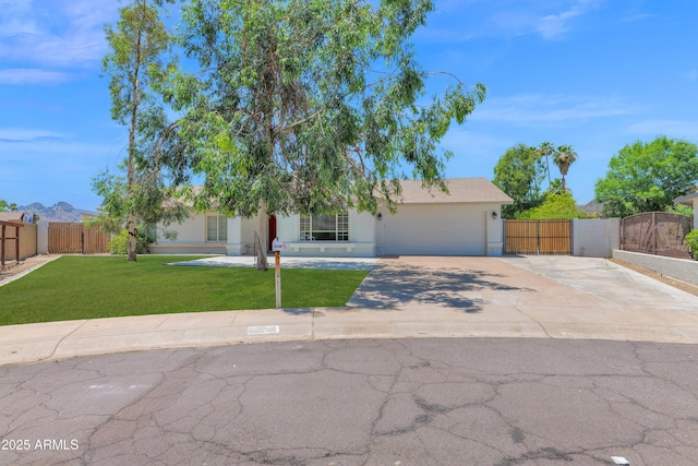 2607 E Mercer Ln, Phoenix, AZ 85028 - obstructed view of property with an attached garage, a gate, concrete driveway, and stucco siding