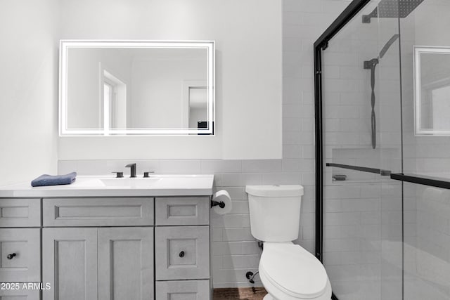 2607 E Mercer Ln, Phoenix, AZ 85028 - bathroom with vanity, a shower stall, tile walls, and a wainscoted wall