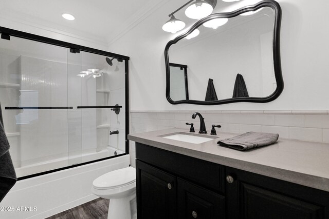 2607 E Mercer Ln, Phoenix, AZ 85028 - bathroom featuring ornamental molding, vanity, enclosed tub / shower combo, and wood finished floors