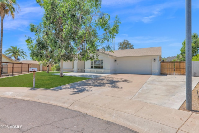 2607 E Mercer Ln, Phoenix, AZ 85028 - view of front facade featuring an attached garage, driveway, stucco siding, and a gate