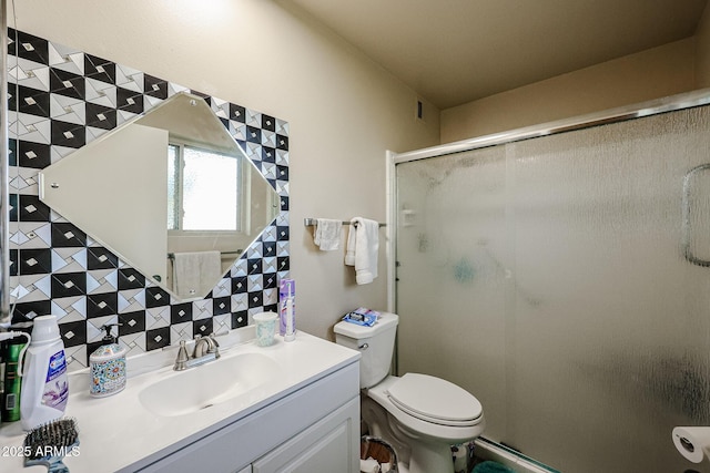 bathroom featuring decorative backsplash, toilet, walk in shower, and vanity