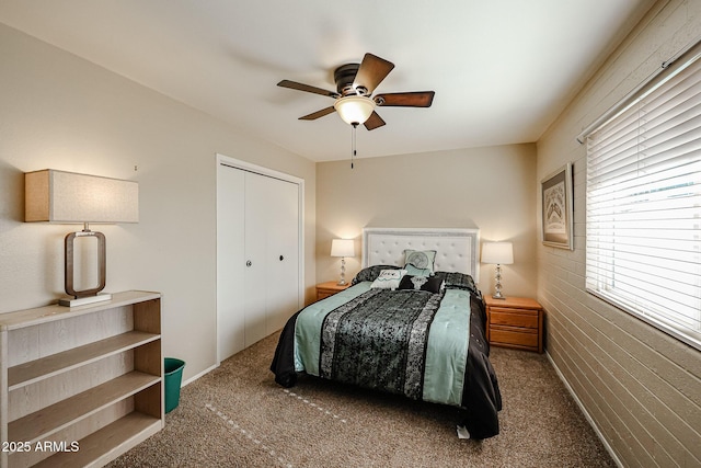 carpeted bedroom featuring ceiling fan and a closet