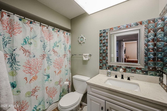 bathroom with vanity, toilet, and walk in shower