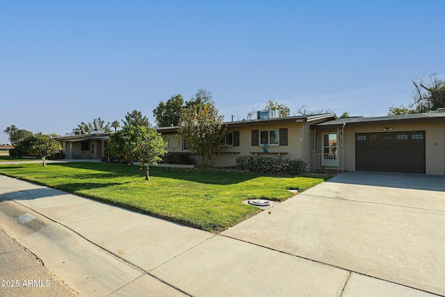 ranch-style home featuring a garage and a front yard