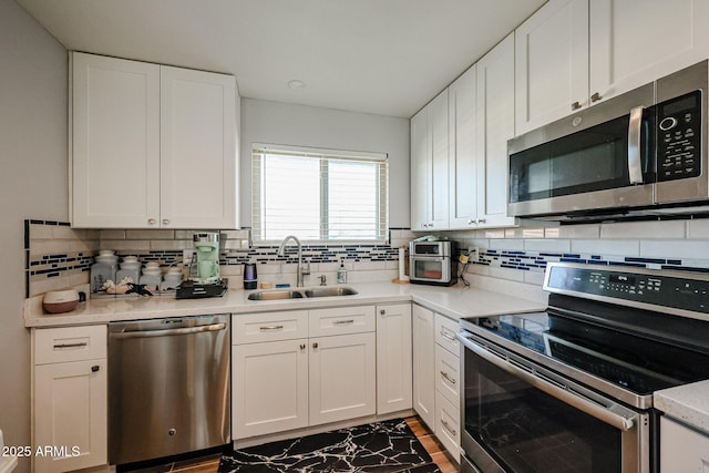 kitchen with white cabinets, sink, and stainless steel appliances